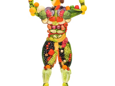 Creative diet food healthy eating concept photo of posing muscular bodybuilder made of fresh fruits ...