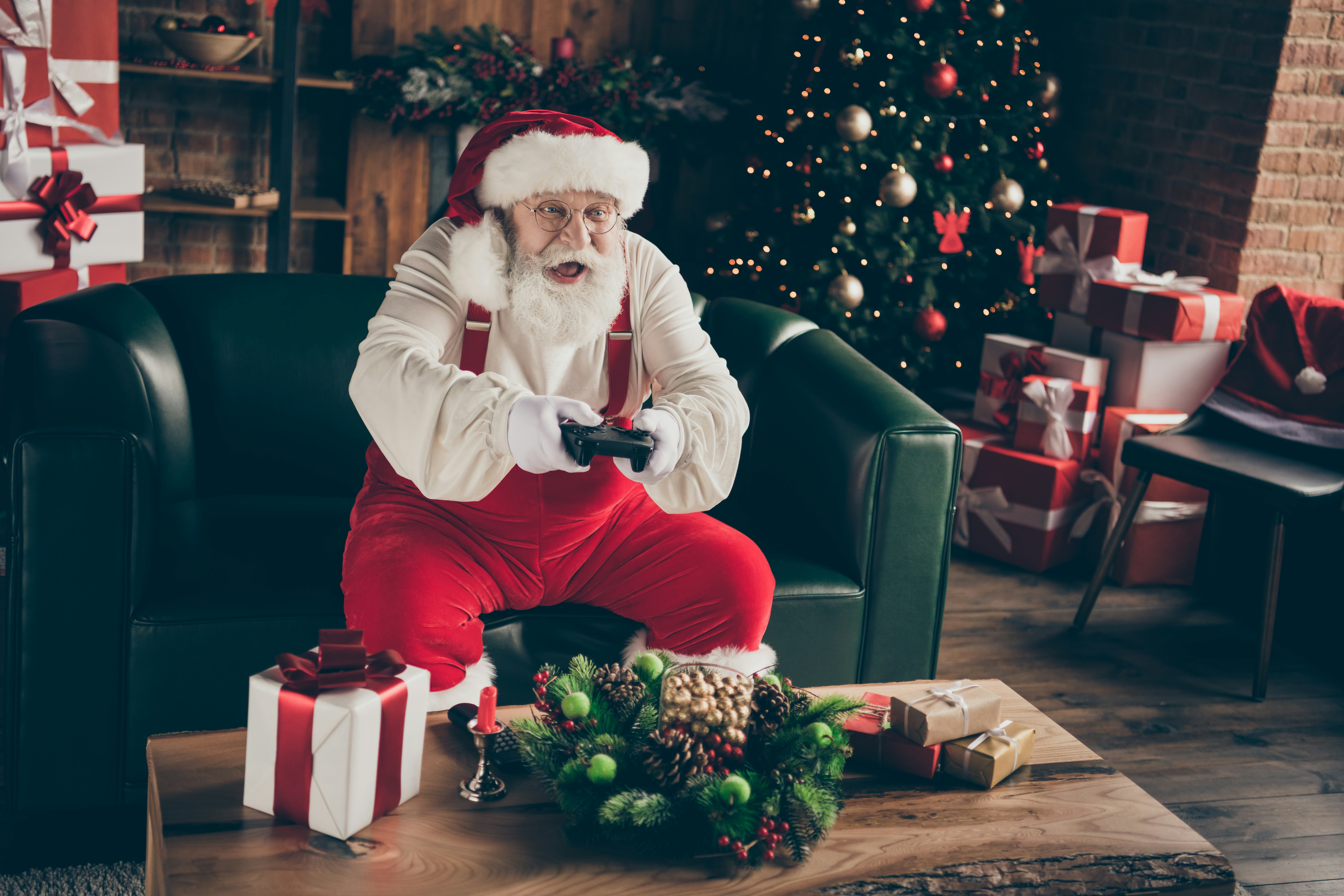 Photo of excited addicted grey hair santa claus sit couch celebrate x-mas christmas night midnight p...