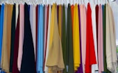 selective focus. Shawls and scarves racks for sale for Muslim women in hijab. colorful women's scarv...