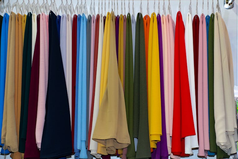selective focus. Shawls and scarves racks for sale for Muslim women in hijab. colorful women's scarv...