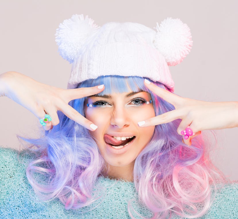 Harajuku e-girl soft girl fashion young woman with pastel blue and pink hair wig, tongue sticking ou...