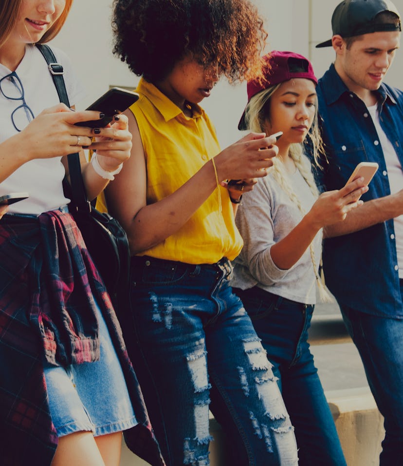 Diverse friends using their phones