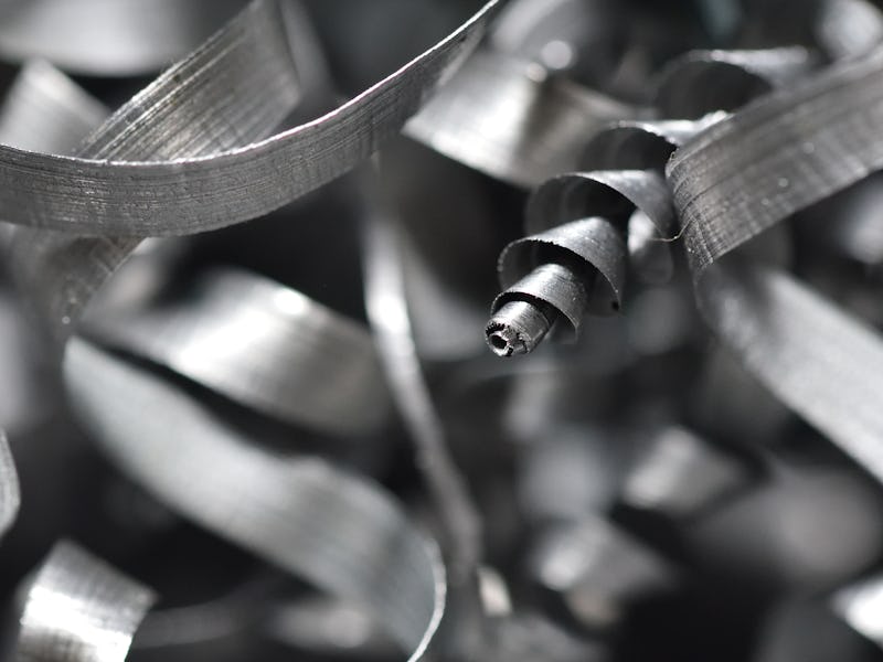 A lot of metal shavings close-up, after working on a milling machine or CNC machine. Texture metal s...