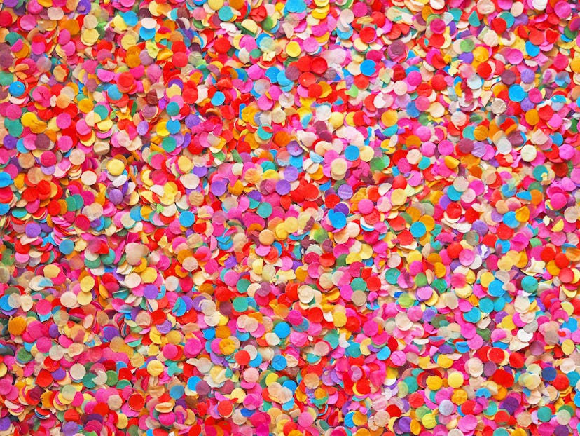 Confetti diversity background. Texture colored circles from paper, close-up. Basis for a festive des...