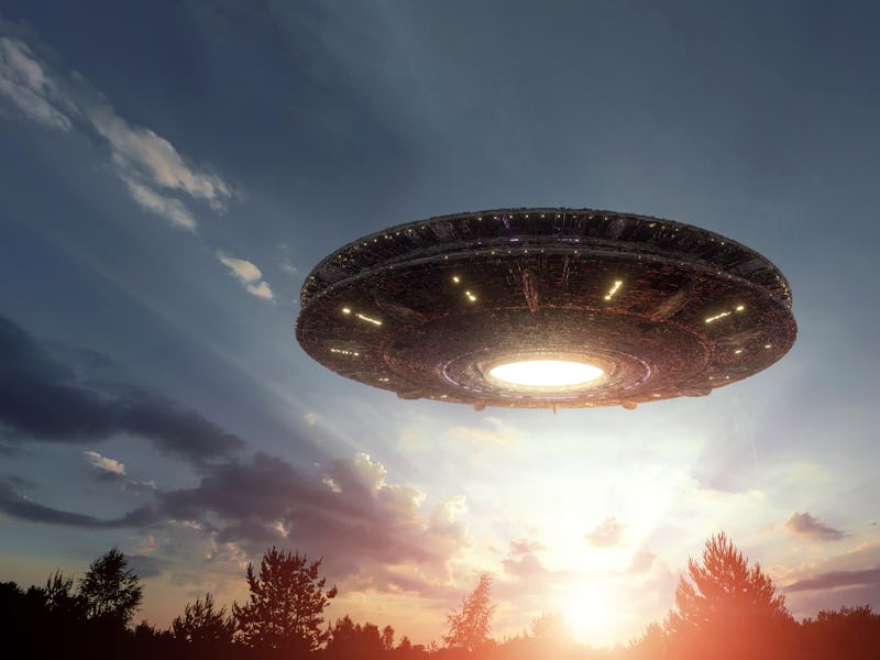 UFO, an alien plate hovering over the field, hovering motionless in the air. Unidentified flying obj...