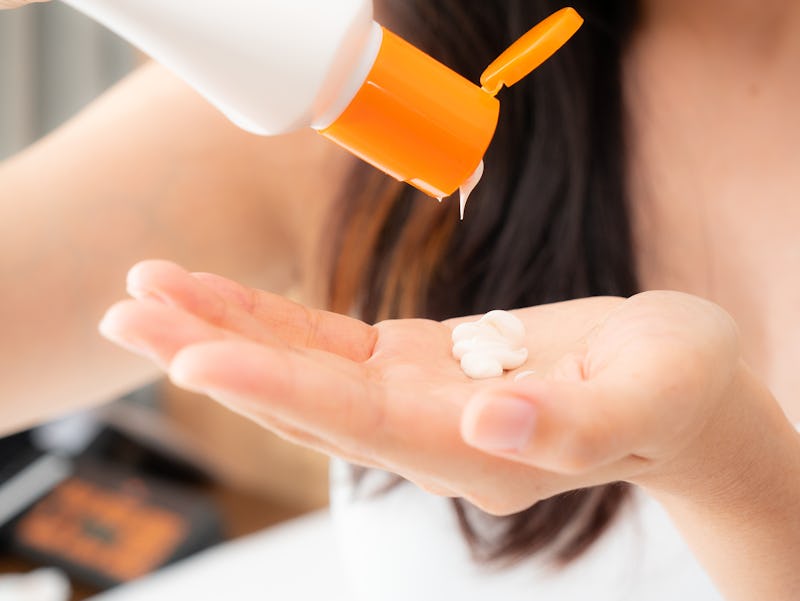 close up of women hands receiving sunblock cream lotion