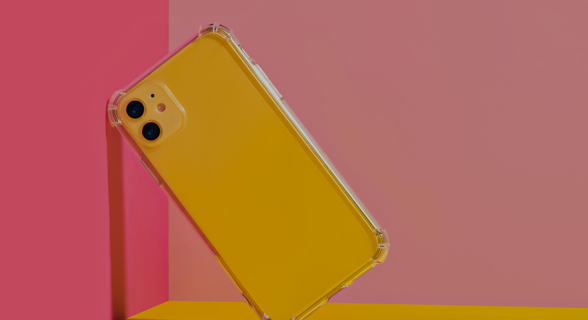 Yellow iPhone 11 in clear phone case, bright and colorful phone case mock up 