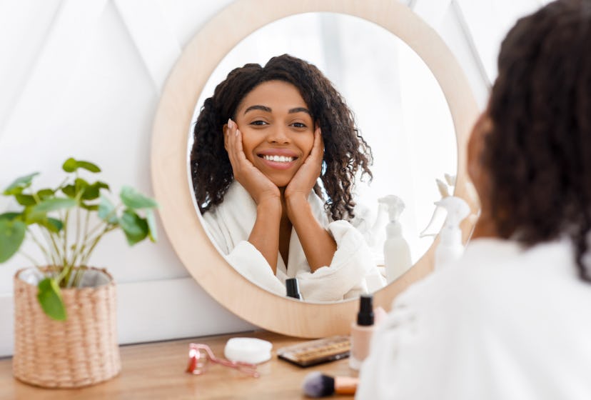 Self-Care. Beautiful African American Woman In Bathrobe Ready To Apply Makeup, Reflecting In Mirror ...