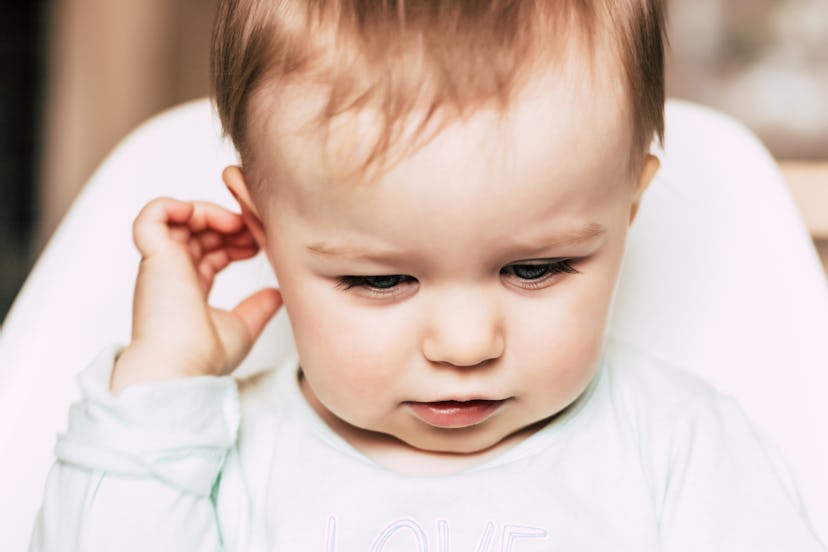 Your baby tugging on their hair isn't always a bad thing.