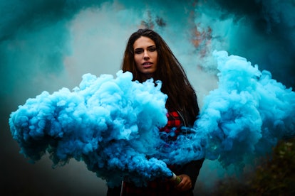 Beautiful girl on a background of colored smoke