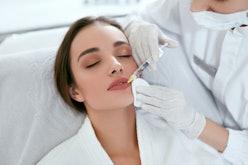 Lip Augmentation. Woman Getting Beauty Injection For Lips