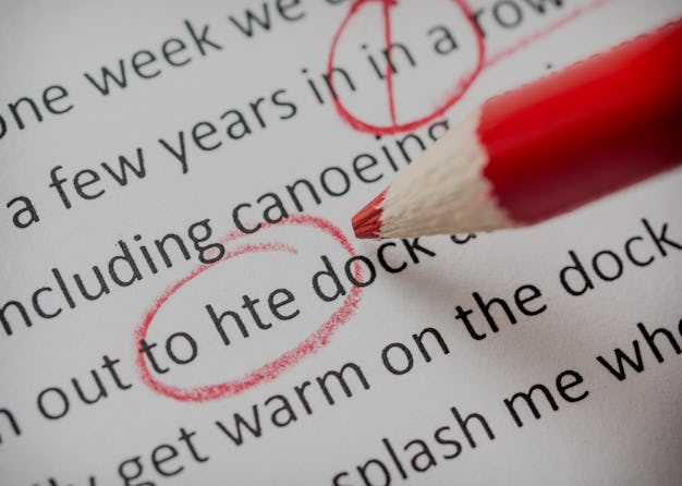 Correcting an essay with red pencil