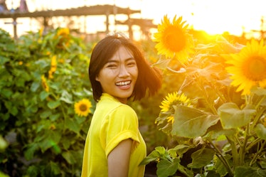 Asian women on the sunflower garden during the summer