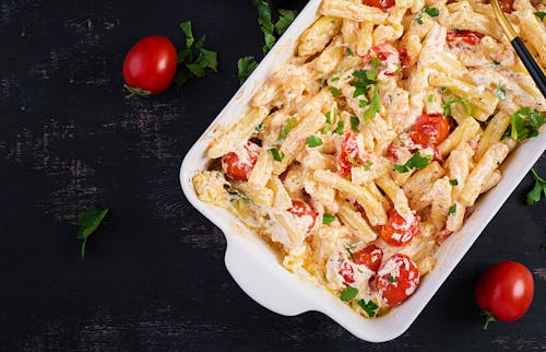 TikTok's viral feta baked pasta recipe made of cherry tomatoes, feta cheese, garlic, and herbs in a ...
