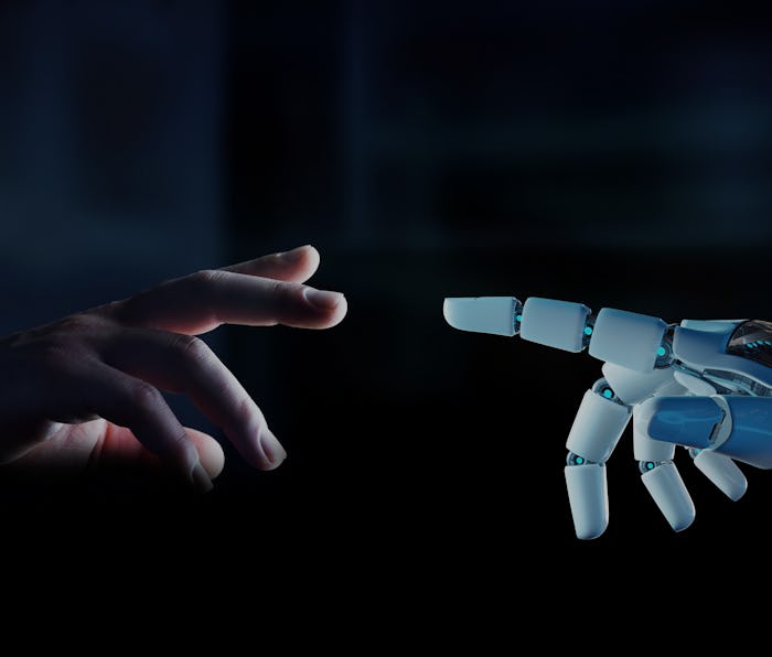 A human finger is seen reaching a robotic finger.