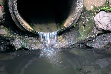 drain pipe or effluent or sewer release wastewater into river. Sewage or domestic wastewater or muni...