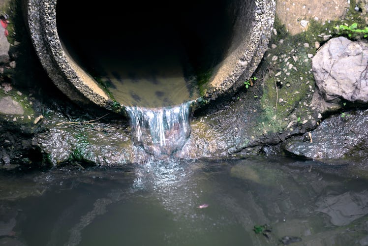 drain pipe or effluent or sewer release wastewater into river. Sewage or domestic wastewater or muni...