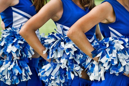 Cheerleaders in Uniform Holding Pom-Poms