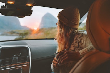 Woman on road trip traveling by rental car relaxing with coffee cup adventure lifestyle vacations vi...