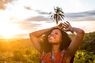 black lady smiling during the beautiful sunset