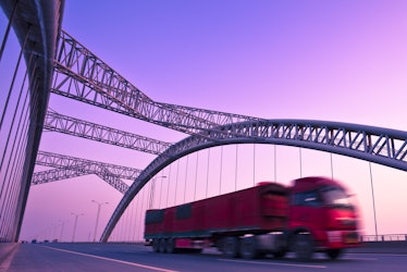 truck speeding through a bridge at sunset,motion blur.