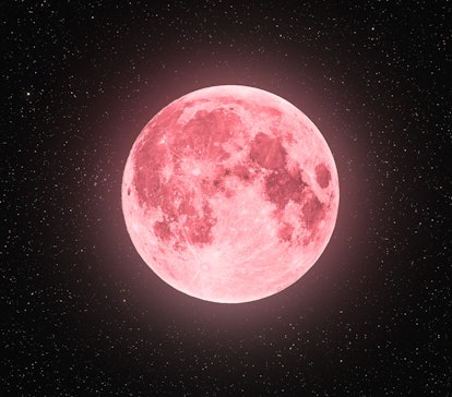 A full moon is glowing in the starry night sky with a pink hue. The spiritual meaning of April's ful...