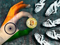 Bitcoin cryptocurrency India flag Golden Coin of Bitcoin in the Indian flag hand giving coin in to h...