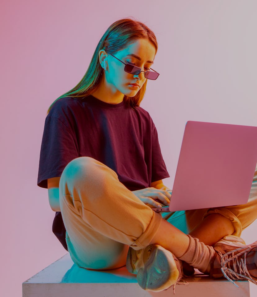 Modern Girl with laptop, tablet computer. Free creativity. Young blogger makes a Home office. Colore...