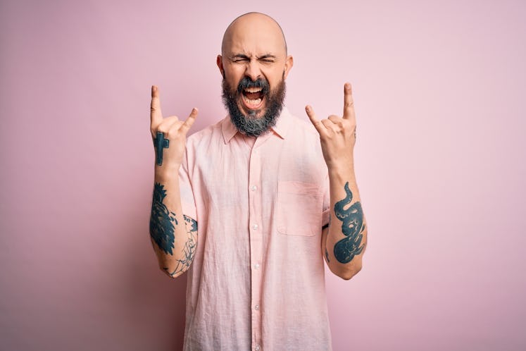 bald man yelling in pink shirt