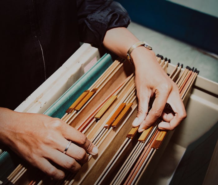 Documents in the office : Top view Bussinesswoman working hand searching Report file in drawer, fili...