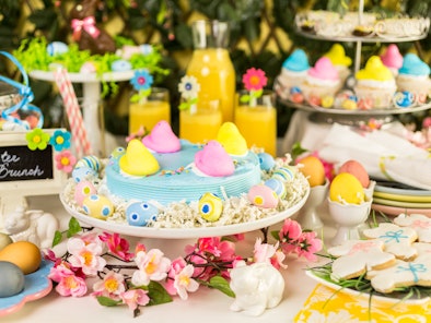 Dessert table with Easter cake decorated with traditional Easter marshmallow chicks.