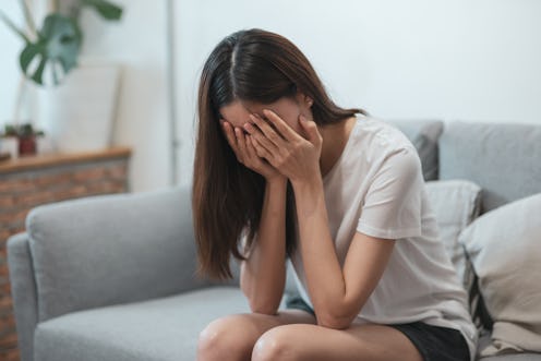 Close up young Asian woman feeling upset, sad, unhappy or disappoint crying lonely in her room.