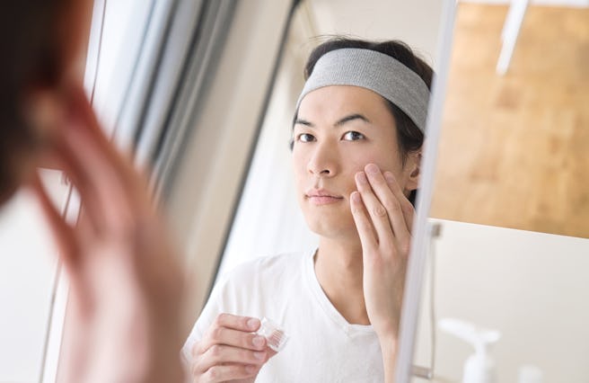 Beauty concept of a young asian man. Skin care.