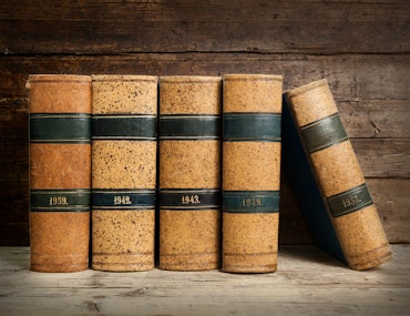 old bound books on vintage wooden background
