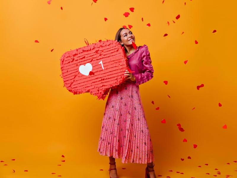 Contented girl with brown hair looks up wistfully, imagining good photo for which she will receive m...