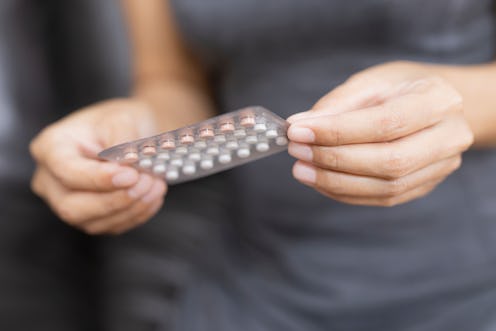 Woman holding combined oral contraceptive pill.Gynecology concept.
