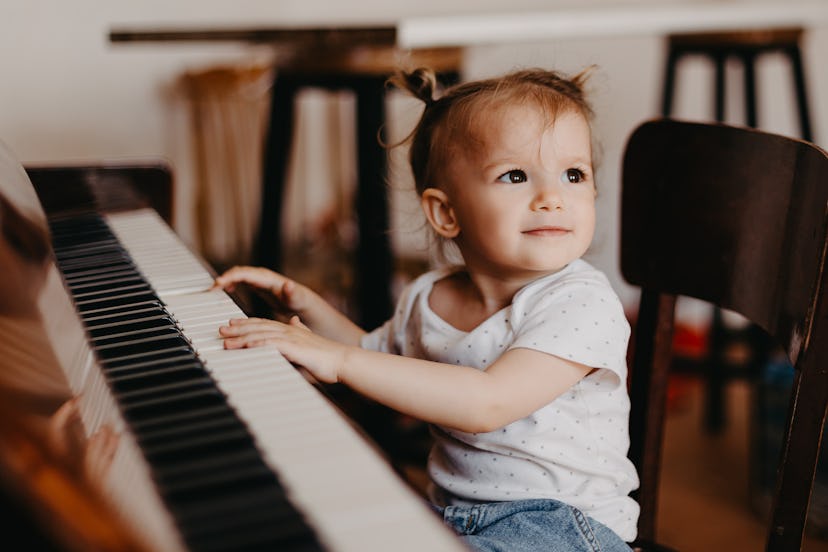 toddler sitting at piano, taurus babies