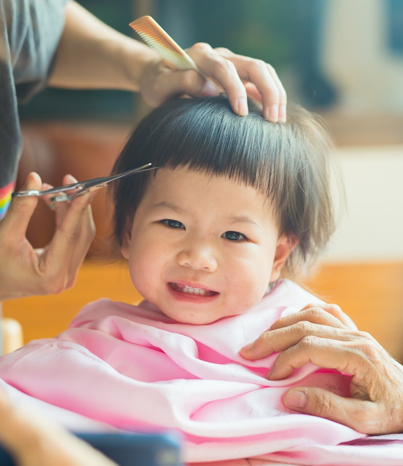 mom cutting baby's hair