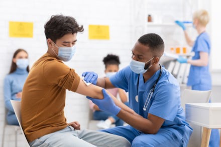 Covid-19 Vaccination. Asian Male Patient Getting Vaccinated Against Coronavirus Receiving Covid Vacc...