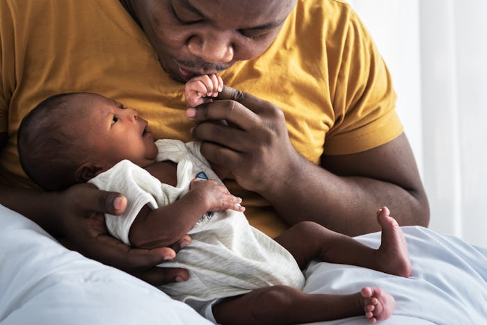 A dad holding a baby.