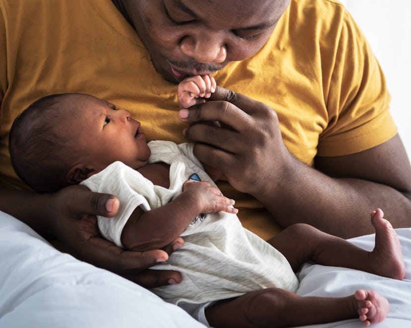 A dad holding a baby.