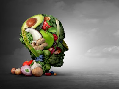 Vegan and vegetarian psychology concept with a group of fruit nuts beans and vegetable as an eating ...