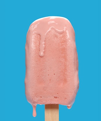 cherry flavor popsicle melting on blue background