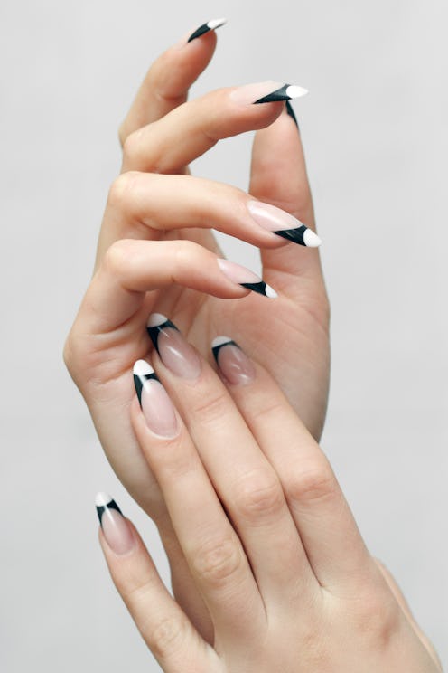 Fall 2022 nail trends include contrasting french manicures, one of fall 2022's new nail art trends.