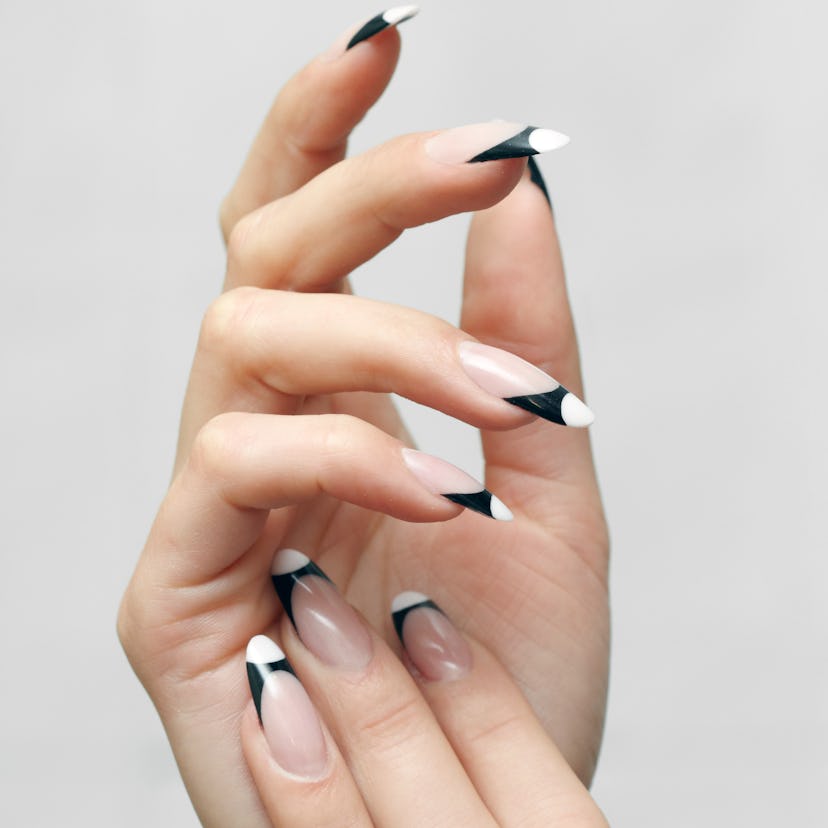 Fall 2022 nail trends include contrasting french manicures, one of fall 2022's new nail art trends.
