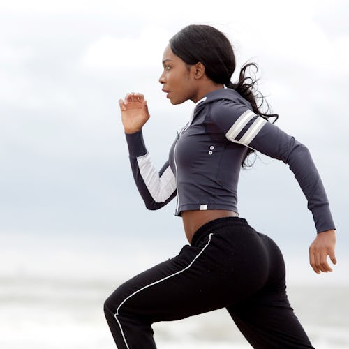 Side portrait of sporty young black woman running