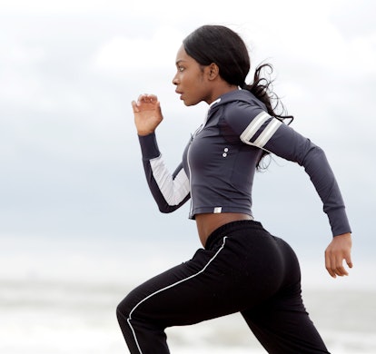 Side portrait of sporty young black woman running