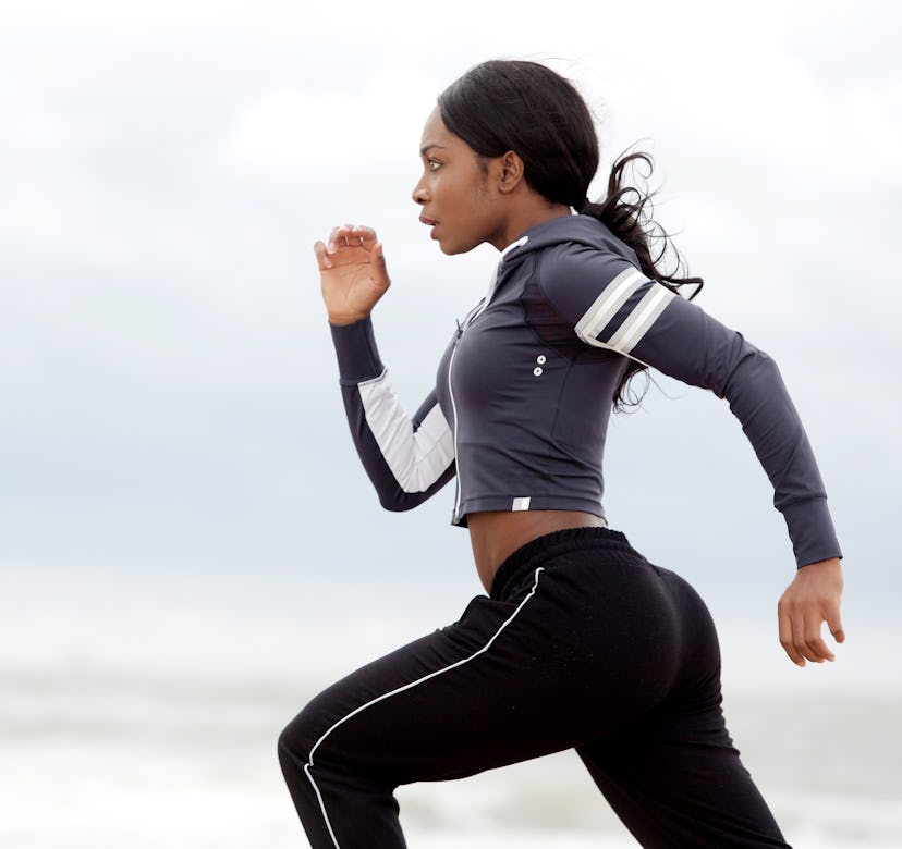 Side portrait of sporty young black woman running