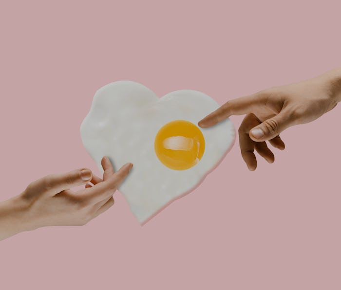 An alternative food. Touch of God - two hands and fried egg against trendy coral background. Negativ...