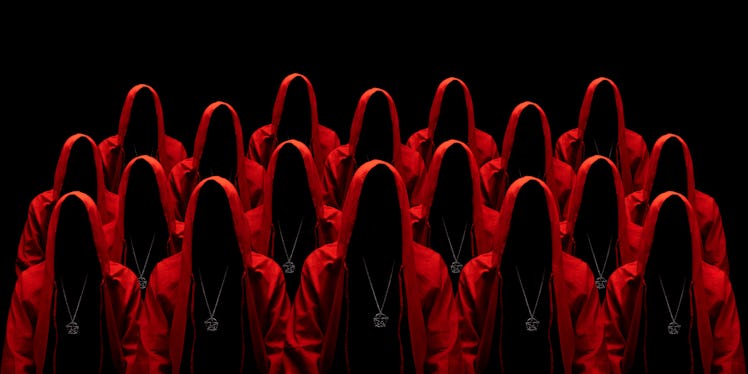 People dressed in a red robes looking like a cult members on a dark background. No face. Occult, sec...